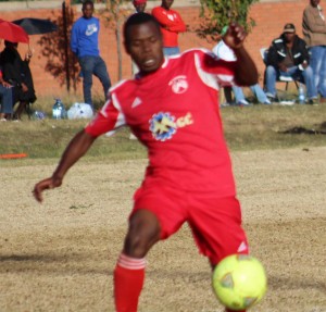 Likhopo left back, in red, Tilane Tau control the ball as Lioli winger, Lekhanya Lekhanya closes-in in a Premier league tie played at Bambatha yesterday