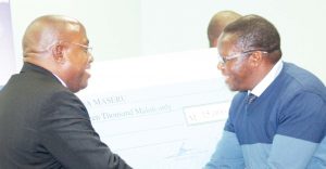 DIFA Maseru president, Qamako Mahao (right) receives the subvention cheaque from Lefa president Salemane Phafane.